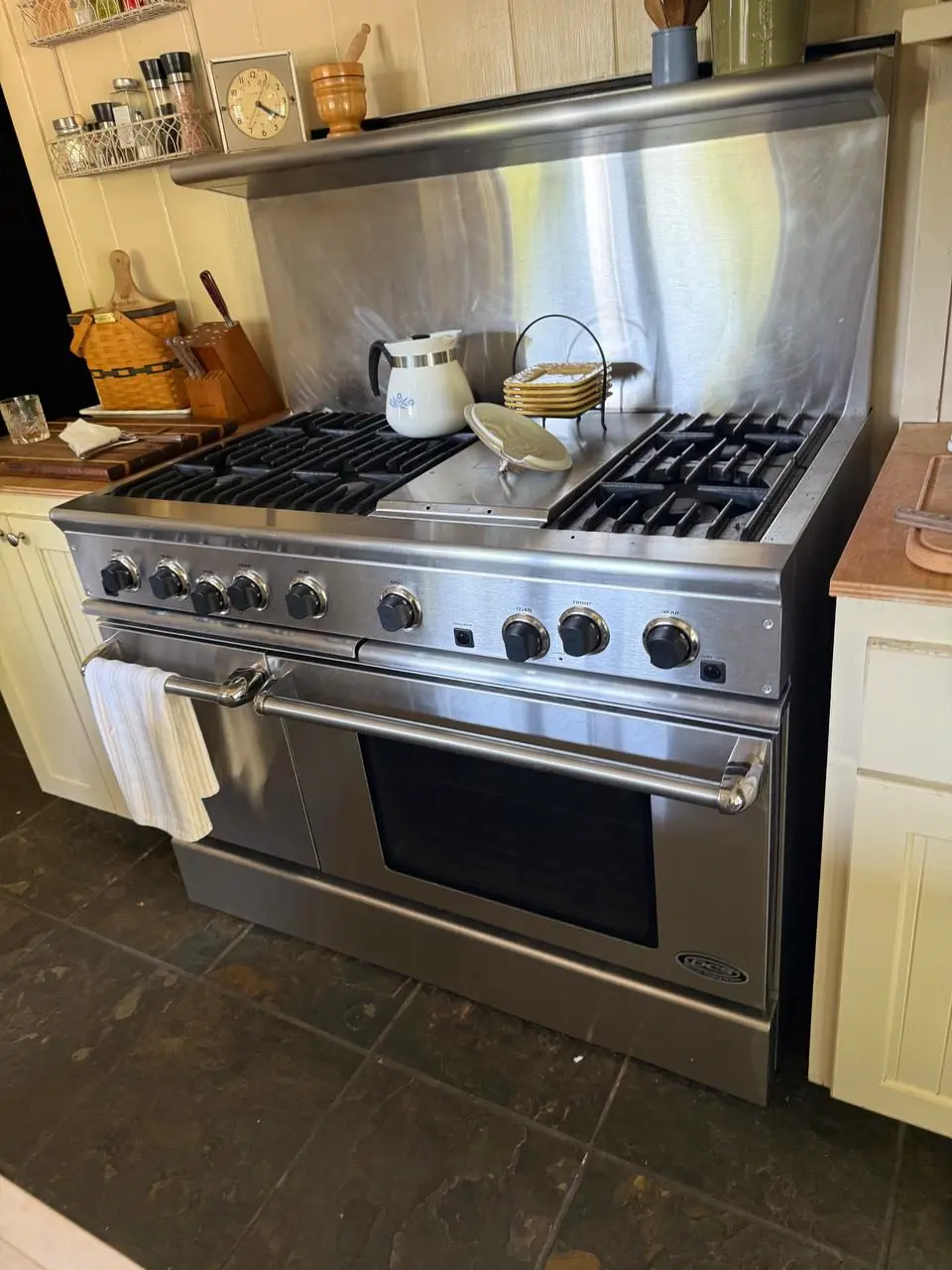 Professional gas range with a stainless backsplash — repaired by Marian Appliance Repair