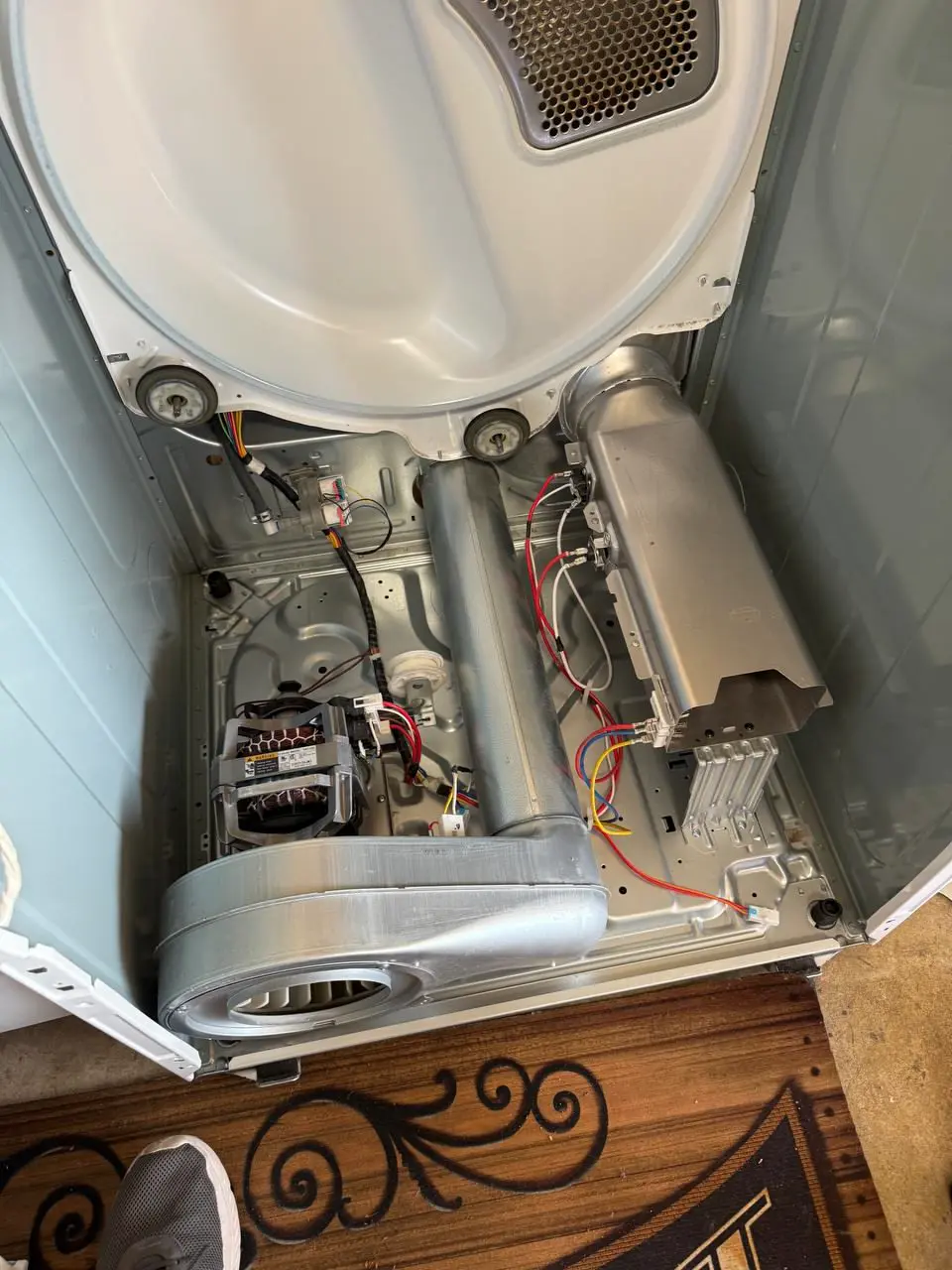 Dryer opened up with the drum removed and heating element exposed — repaired by Marian Appliance Repair