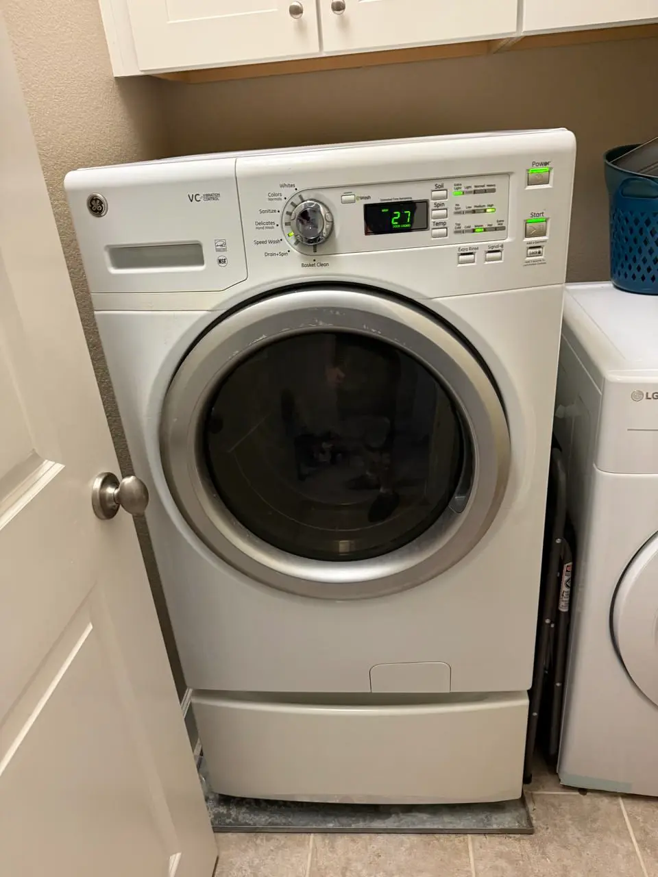 Front-load washer in a laundry closet — repaired by Marian Appliance Repair