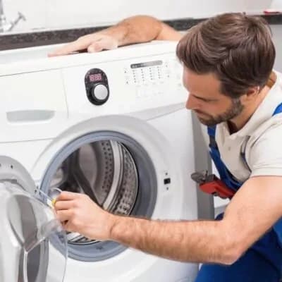 Technician servicing a clothes dryer