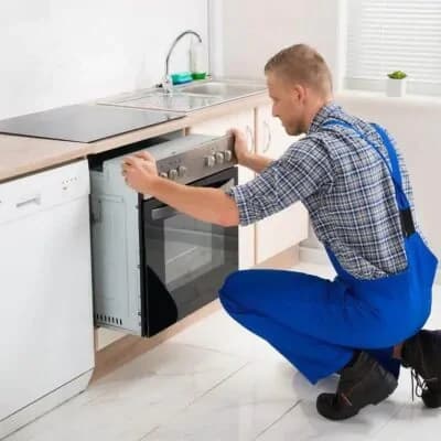 Technician installing an electric range